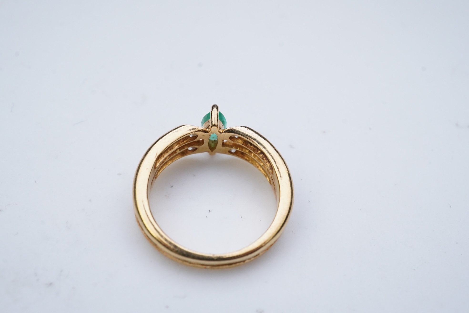 An emerald and diamond ring